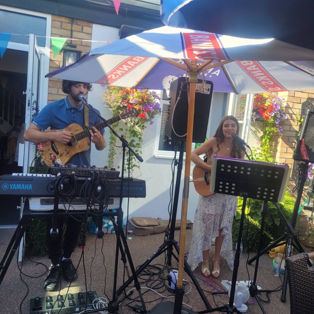 Live acoustic duo playing on the terrace at Phoenix Fest